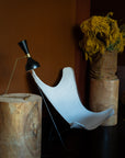 Authentic original 1960s Knoll BKF Butterfly Chair designed by Ferrari-Hardoy with an off-white French linen canvas cover against a brown wall.